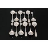 A set of twelve hallmarked silver fiddle pattern soup spoons of plain form, total weight 29oz,