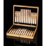 An oak cased set of twelve Art Deco hallmarked silver and mother of pearl handled fruit knives and