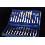 A cased set of twelve Art Deco hallmarked silver and mother of pearl handled fish knives and forks,