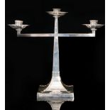 An Arts and Crafts style silver plated three branch candelabra in the manner of James Dixon,