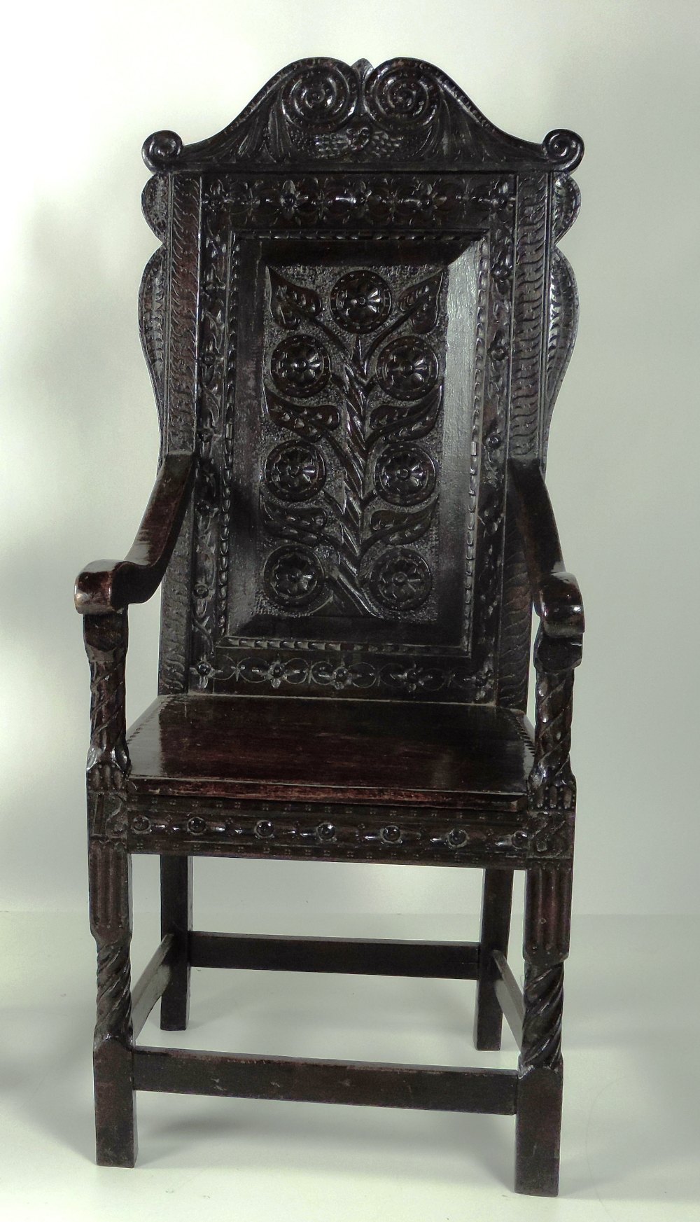 An exceptionally heavy carved and blackened oak Cromwellian style high back Armchair,