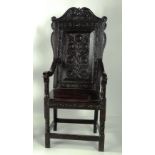 An exceptionally heavy carved and blackened oak Cromwellian style high back Armchair,