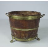 A good old brass bound oak Bucket, with brass handles, on three brass paw feet.