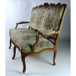 A large 19th Century carved and painted French Settee, the shaped back over outsplayed arms,