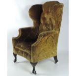 A very large 19th Century high back Wing Armchair, on short front cabriole legs,