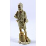A tall 19th Century carved and engraved Japanese ivory Okimono, of a man with baskets etc,