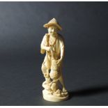A small late 19th Century carved Japanese ivory Okimono of Fish Seller,