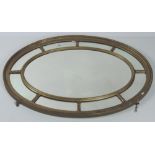 An attractive late 19th Century giltwood oval Wall Mirror,