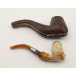 An unusual 19th Century carved Meerschaum Pipe, modelled as a hand holding a bowl, with amber stem,