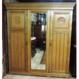 An attractive late Victorian bleached oak Wardrobe, with centre mirror door,