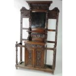 An unusual and large 19th Century oak Hall Stand, the entire profusely carved with lion masks,
