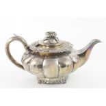 An English George IV silver melon shaped Teapot, with embossed lid, decorated rim,