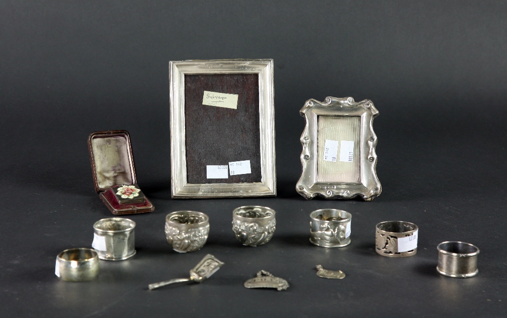 Two small silver Photograph Frames, two silver Wine Labels, a small silver Caddy Spoon,