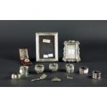 Two small silver Photograph Frames, two silver Wine Labels, a small silver Caddy Spoon,