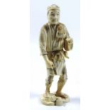 A 19th Century carved and engraved ivory Okimono of a native Japanese man,
