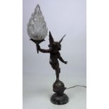 An unusual figural Table Lamp, modelled as a winged cherub, holding a flame shaped shade,