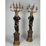 A large pair of attractive nine branch composition Blackamoor Standard Candelabra, on circular