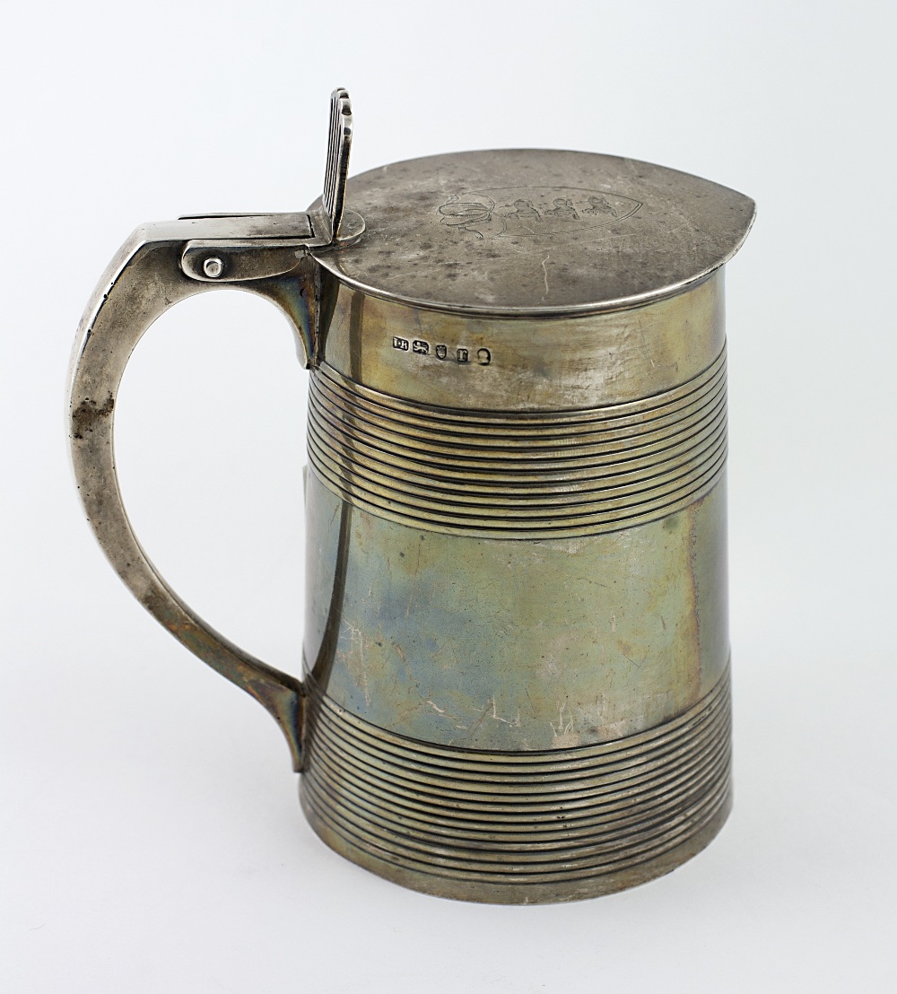 An important heavy George III English silver Tankard, the hinged lid with an engraved coat of arms,