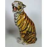 A large glazed Italian earthenware model of a seated Tiger, in naturalistic colours, approx.