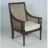 A Regency style Bergere Armchair, with cane work back and seat,