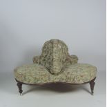 A good quality Victorian walnut three seat Tete a Tete Settee, upholstered in floral tapestry,