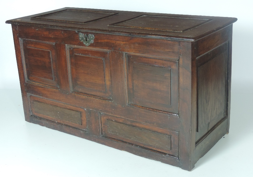 A 19th Century and later oak Coffer, with plank top, and with three carved panels on front,