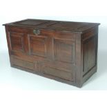 A 19th Century and later oak Coffer, with plank top, and with three carved panels on front,