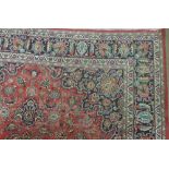 An attractive wine ground Carpet, Oriental style with large centre design surrounded by flowers etc.