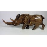 A heavy carved wooden model of a Rhinoceros, 112cms (44") long.