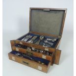 An oak Cutlery Canteen, by Cross Brothers, Cardiff, with a part service, kings pattern design,
