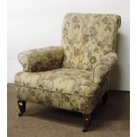 A very large late 19th Century Easy Armchair, covered in floral tapestry.