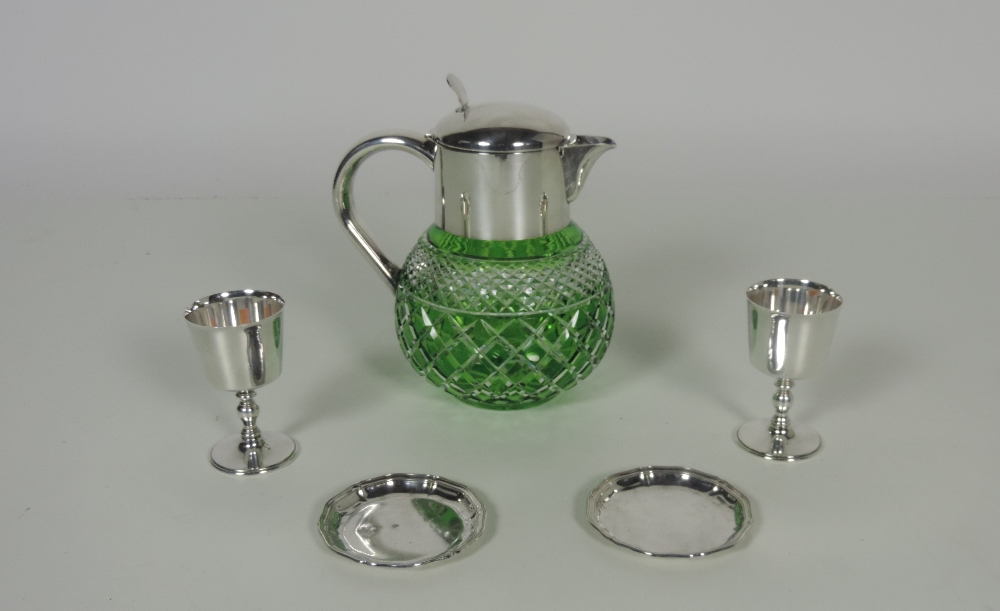 An unusual green cutglass Punch Jug, with heavy silver plated mount and handle,