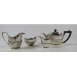 A small four piece Bachelors Tea Service, teapot with wooden handle, sugar bowl,