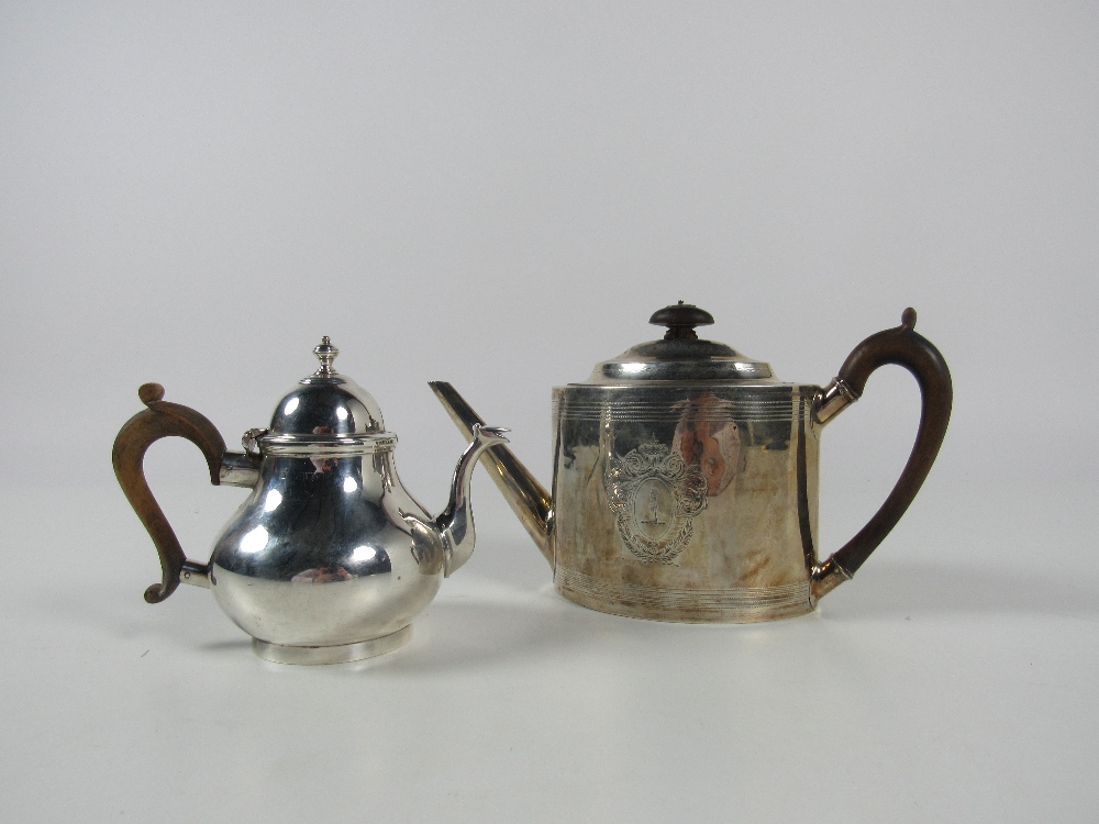 An English Georgian silver Teapot, of oval form, with engraved decoration and coat of arms,