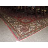 A large crimson ground Carpet, with elaborate floral design centre and large cream ground border,