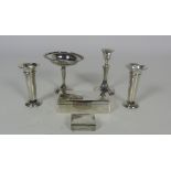 A rectangular silver Cigarette Case, a pair of silver Vases, a single silver Candlestick,