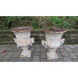 A good pair of mid-19th Century Garden Urns, the circular bodies with floral and other decoration,