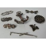 A collection of eight varied Edwardian silver Brooches.