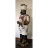 A large late 19th Century carved life size wooden Figure of a Chef, with painted decoration,