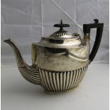 A large English silver Teapot, with reeded body and wooden handle, Sheffield c.