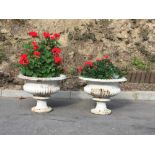 A pair of heavy Victorian metal Garden Urns, each with reeded rim and body on circular bases,