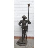 A tall metal and brass Figure of a Medieval Actor holding a large torch pole,