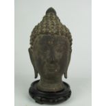 An early Thai bronze Head of Buddha, possibly late 17th Century, 25.5cms (10") high.