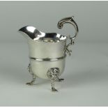 An exceptionally fine George II Irish Provincial Cream Jug, with heavy cast flying scroll handle,