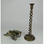 A heavy brass Desk Cannon, with engraved decoration; and a tall twisted brass Candlestick,