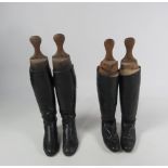 Two pairs of leather Riding Boots, with wooden stretcher.