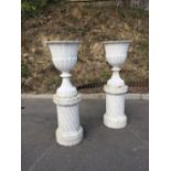 A large pair of Victorian cast iron tulip shaped Urns, on cylindrical stands, each approx.