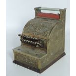 A good early 20th Century heavy embossed bronze National Cash Register, decorated with flowers,