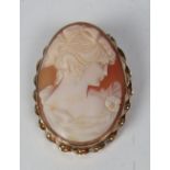 A finely carved Cameo Brooch of a Young Girl, in a decorated gold frame.