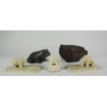 A pair of small 19th Century carved ivory elephant Paper Weights, on ivory platform bases,